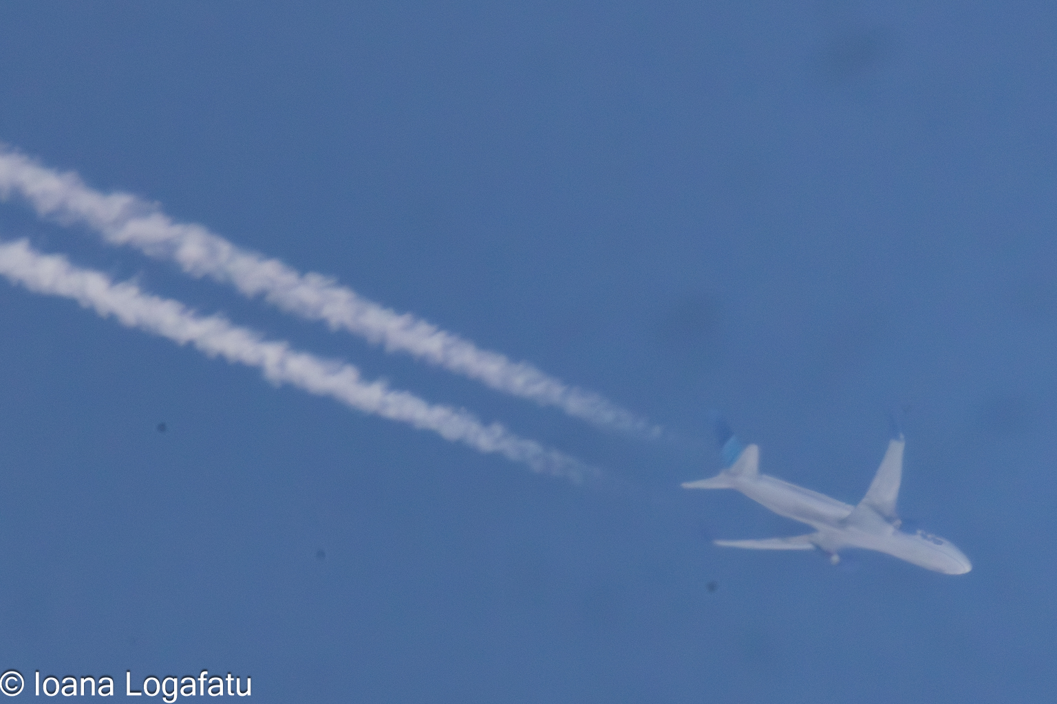 High-flying jet trails create patterns in the sky